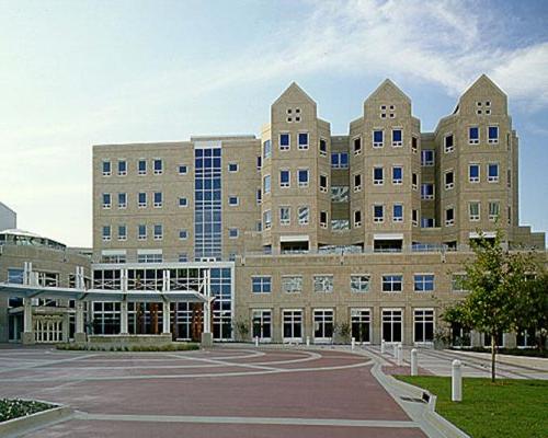 Exterior photo of Wolfson Children's Hospital during the day. Brick drive leads up to six-story tan bricked building.